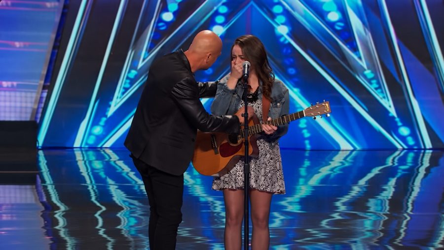 Singer performing on the America's Got Talent stage.