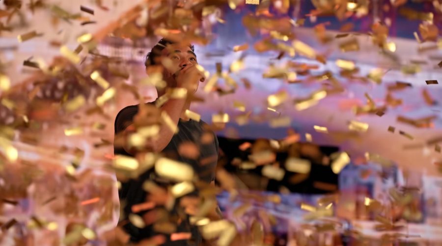 U.S. Army Sergeant Isaac Atkins celebrating under golden confetti after earning Mel B's Golden Buzzer on America's Got Talent.
