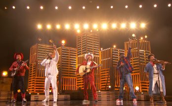Five brothers performing together on a talent-show stage.